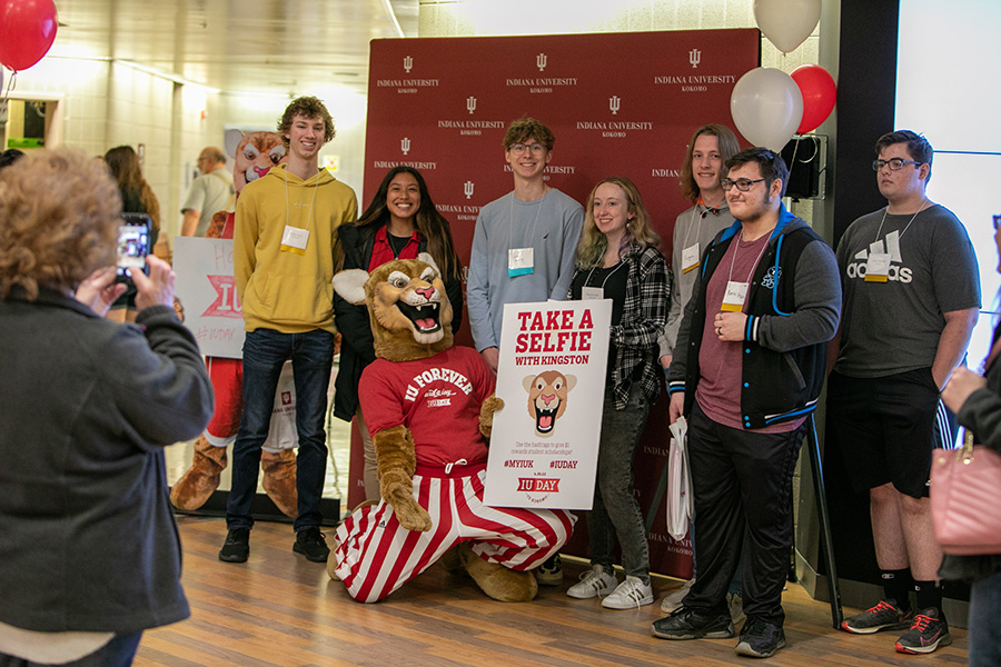 Kingston standing with several students holding a selfie.
